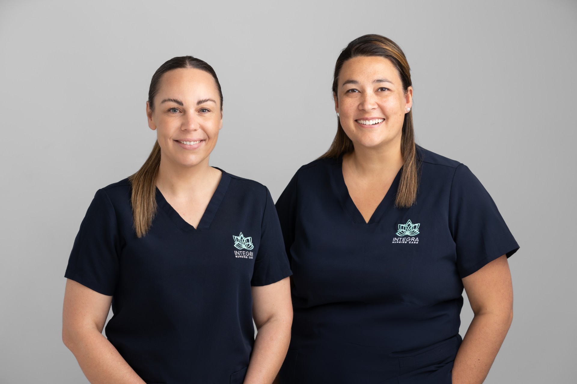 Two employees at Integra Nursing Care smiling at the camera